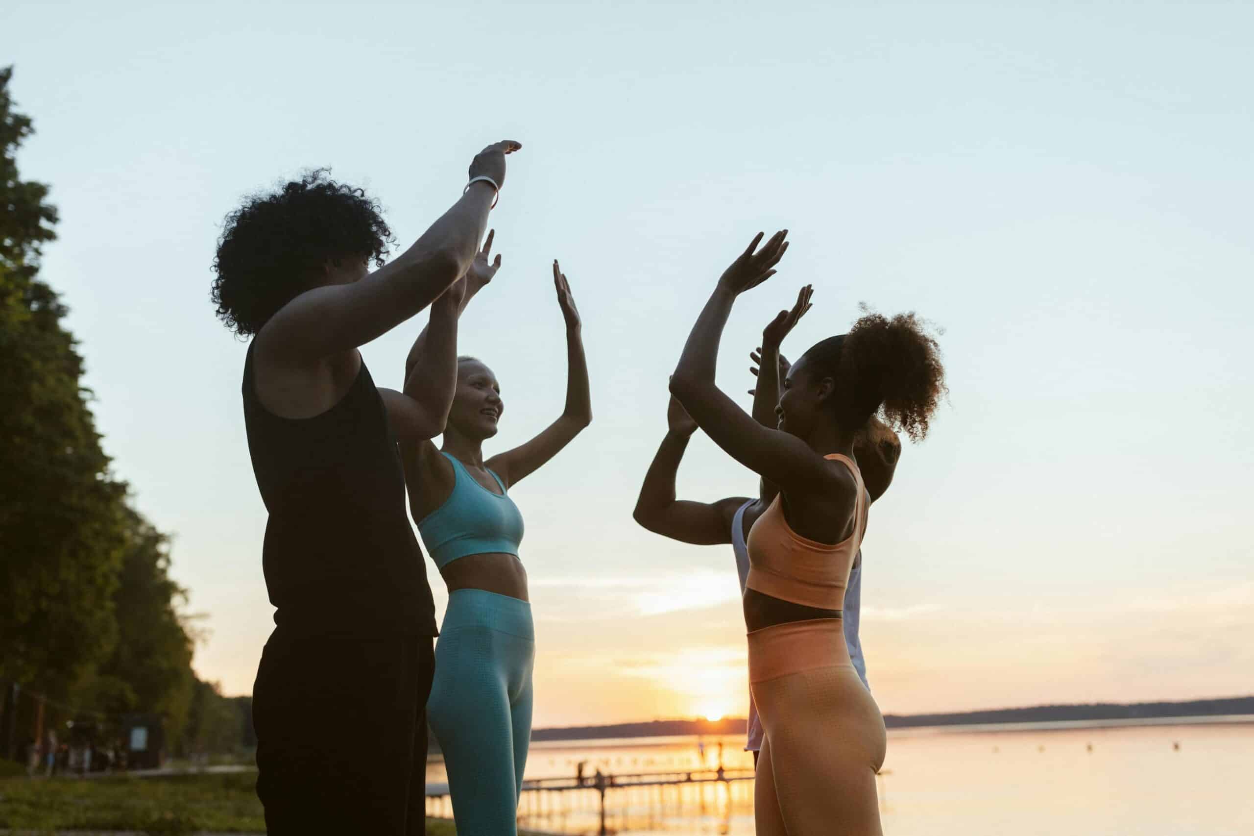 Women in athletic clothing at sunset